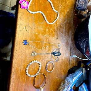 7 jewelry pieces-three necklaces, three bracelets, and on bracelet ring
